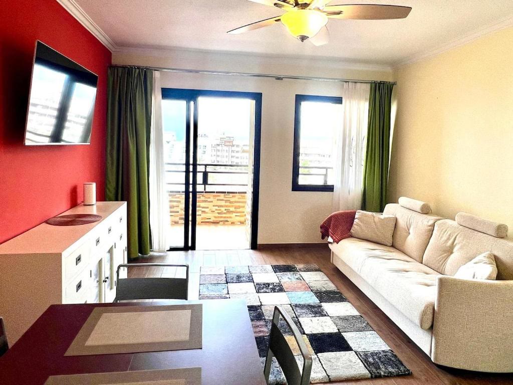 Living room with sofa, TV and balcony