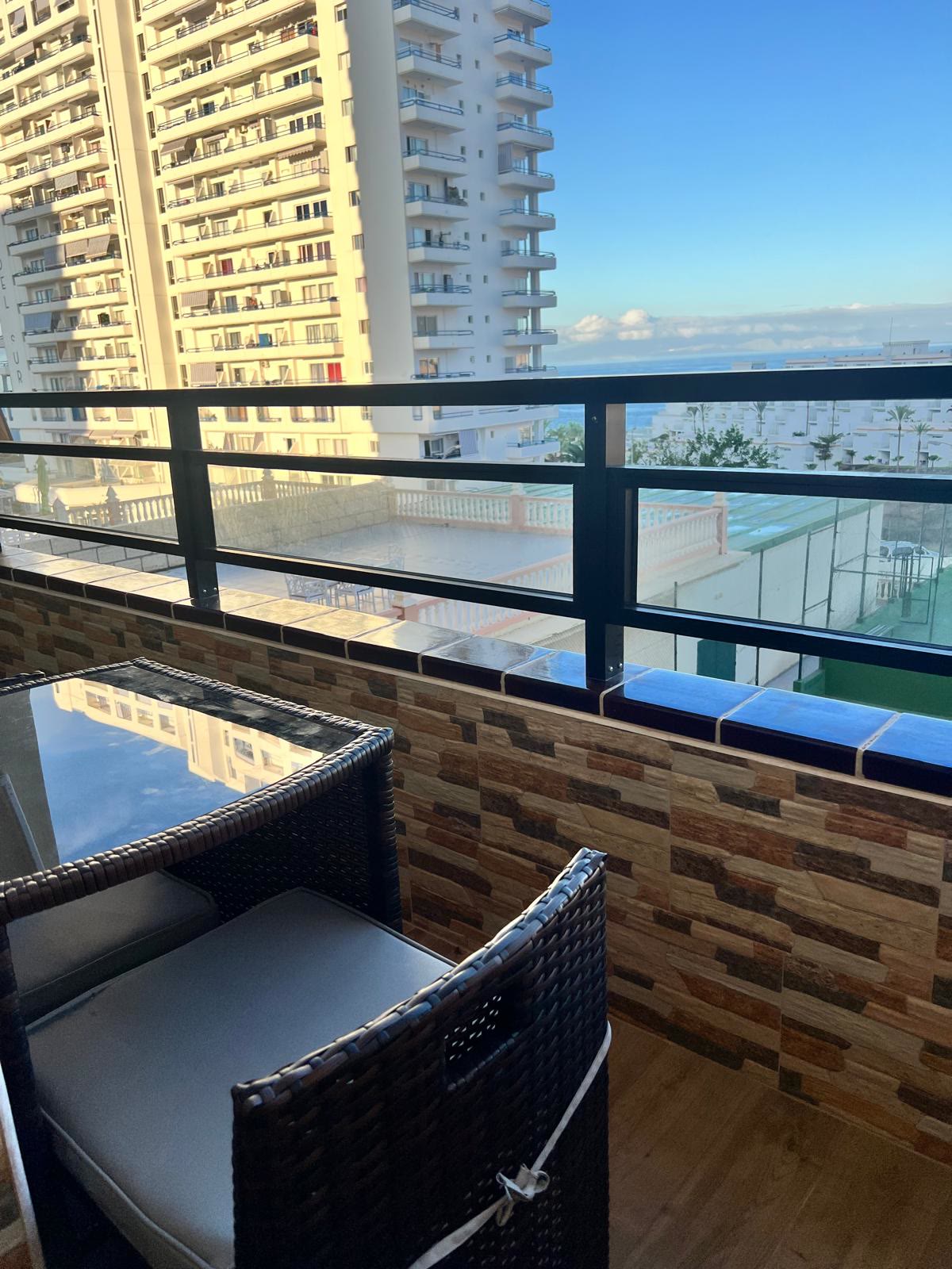 Private balcony with rattan furniture and sea view